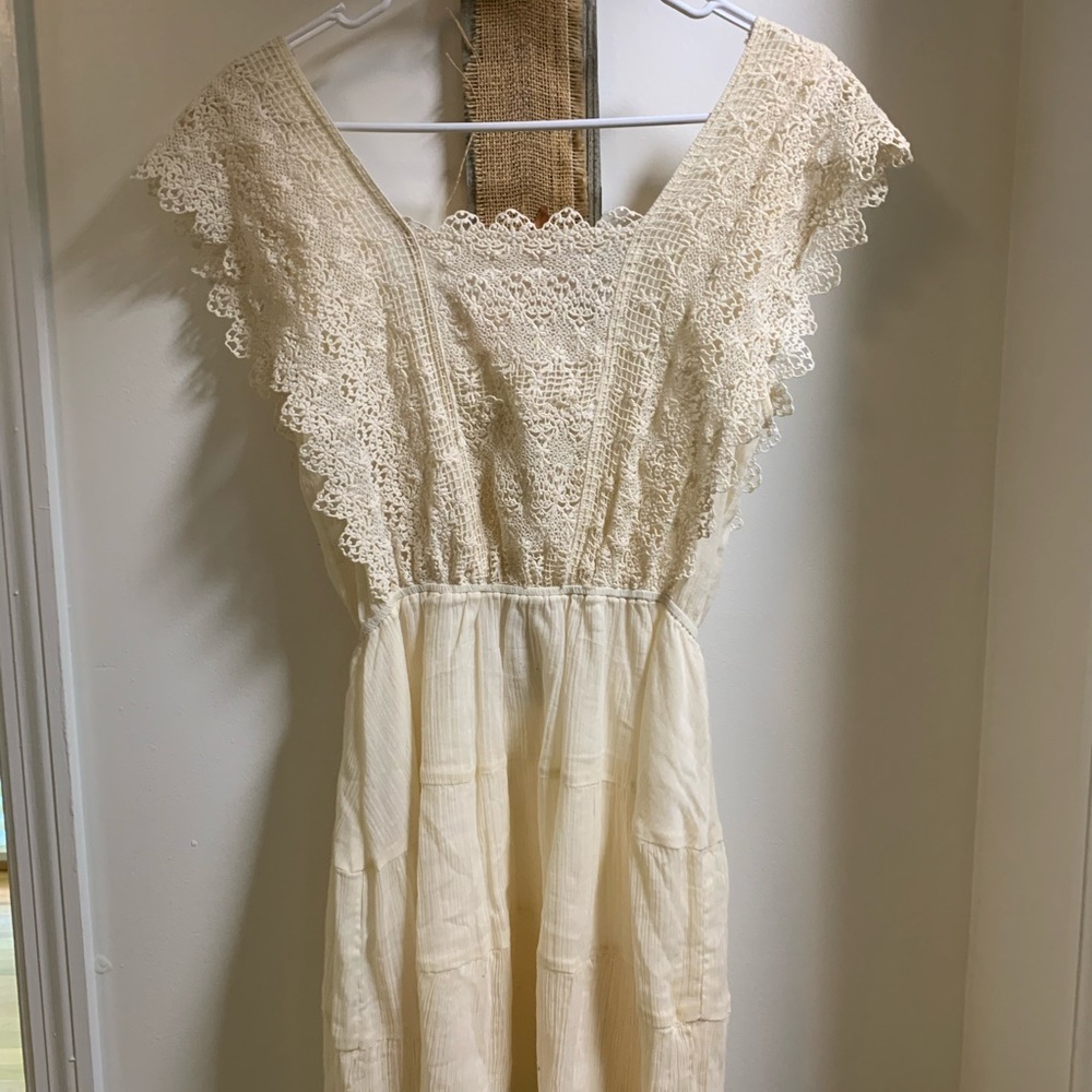 A gorgeous creamy white dress, made by Moon River.